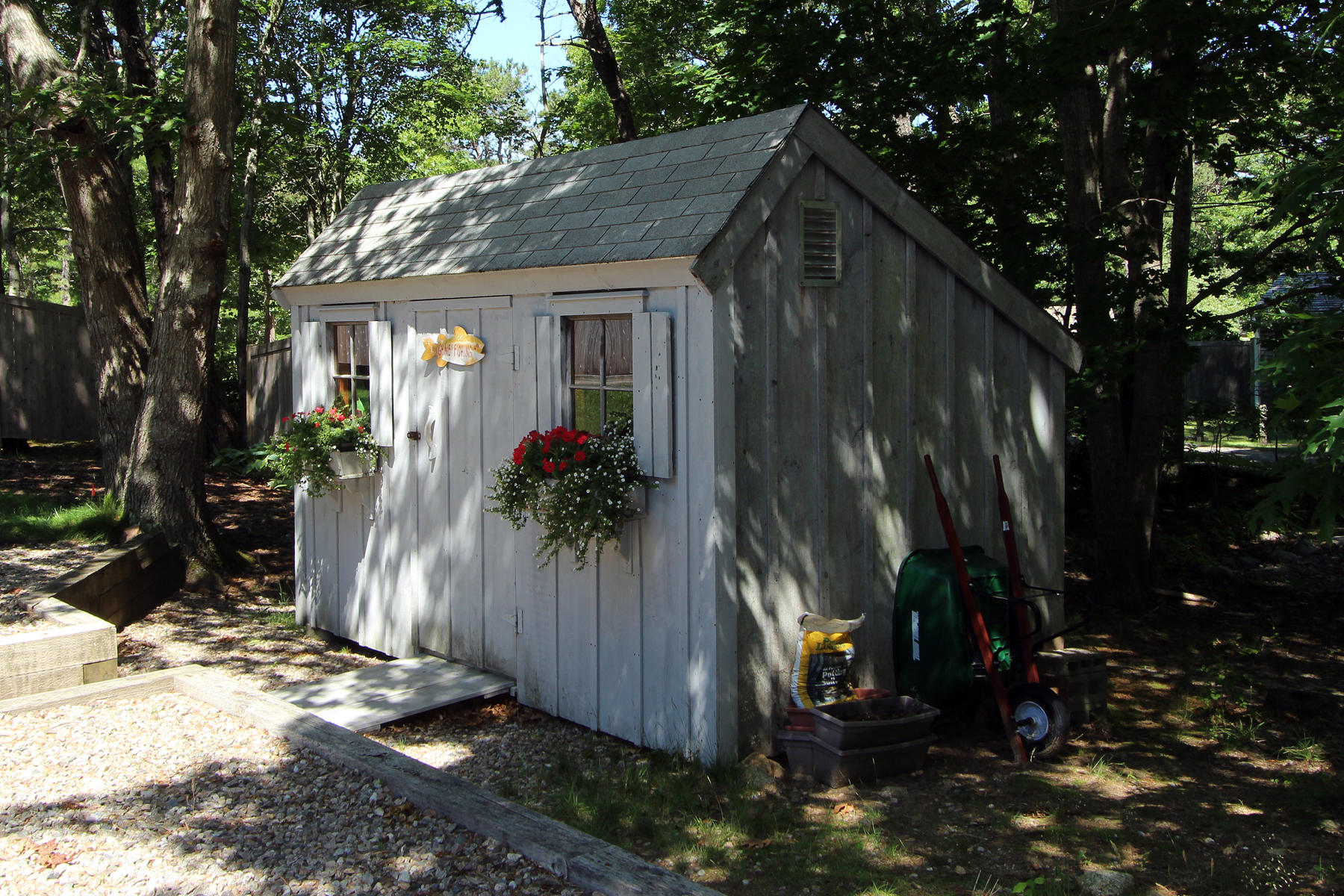 195 Cathedral Road Brewster, MA 02631 - Photo 8 of 54 a view of a house with potted plants next to yard