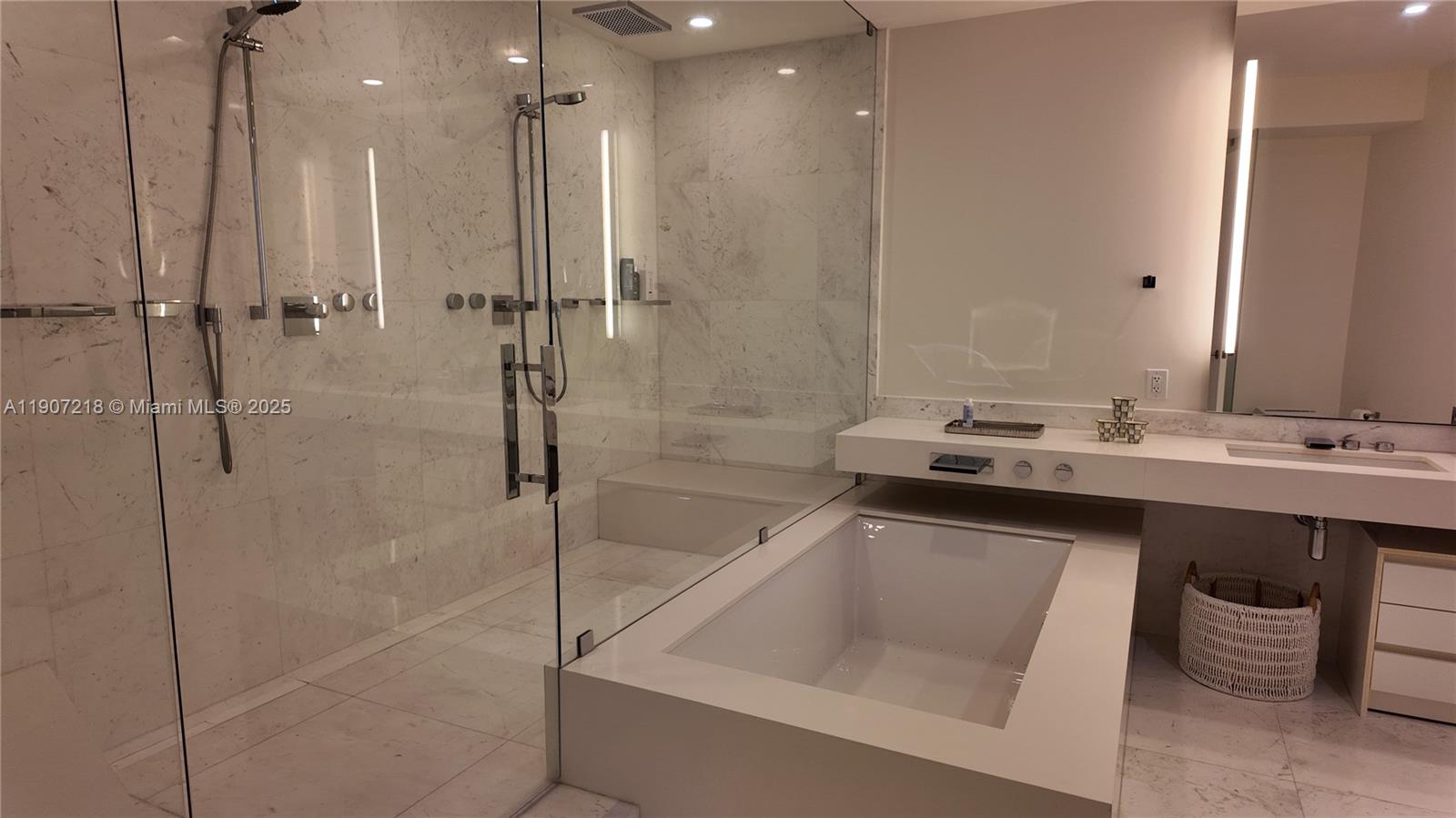 18555 Collins Avenue, Unit 905 Sunny Isles Beach, FL 33160 - Photo 11 of 38 a bathroom with a sink a toilet and shower