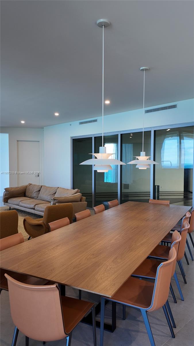 18555 Collins Avenue, Unit 905 Sunny Isles Beach, FL 33160 - Photo 4 of 38 a view of a dining room with furniture