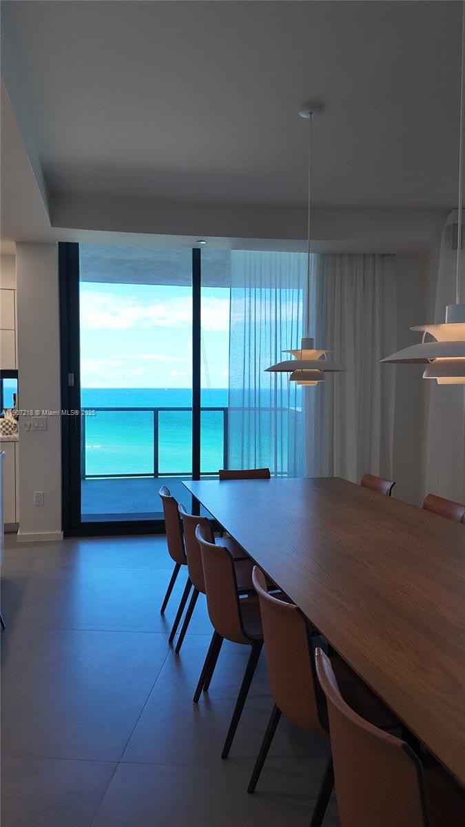 18555 Collins Avenue, Unit 905 Sunny Isles Beach, FL 33160 - Photo 8 of 38 a room with furniture and window