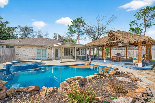 a view of a house with swimming pool and sitting area