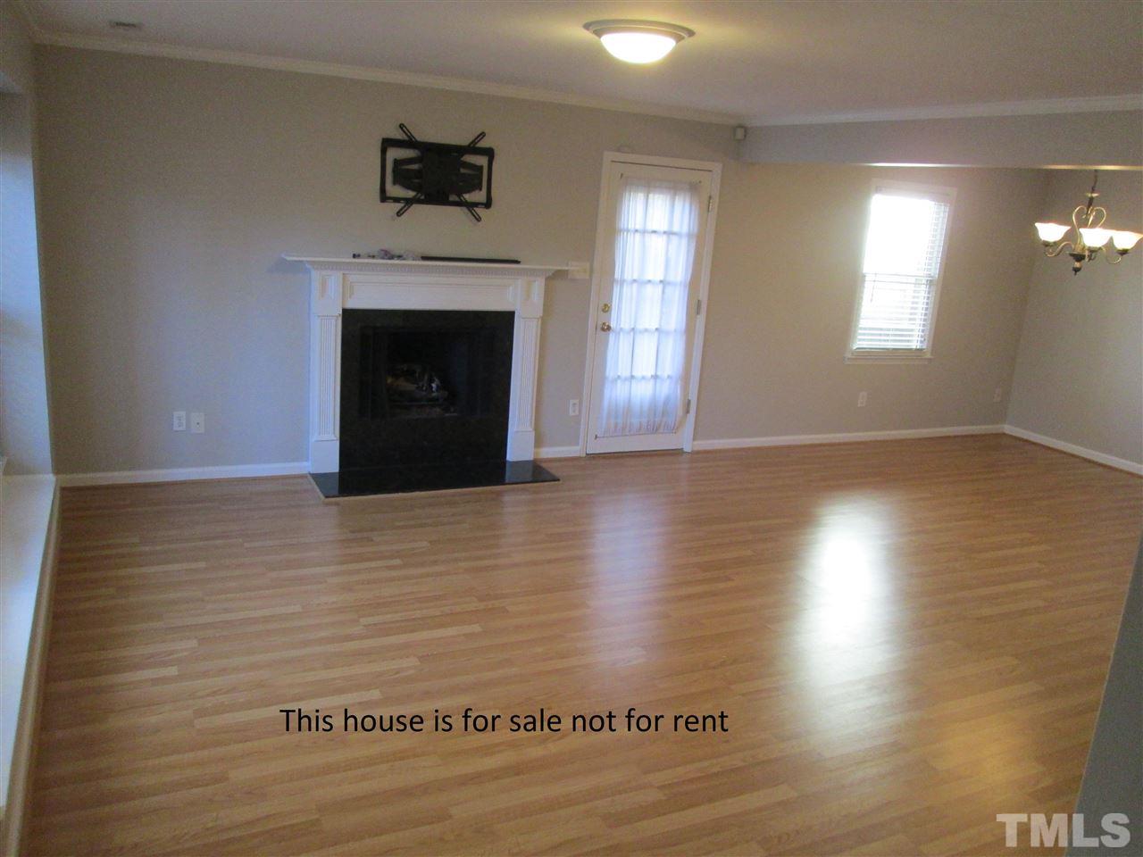 5513 Hamstead Crossing Raleigh, NC 27612 - Photo 4 of 30 a view of a livingroom with wooden floor and a fireplace
