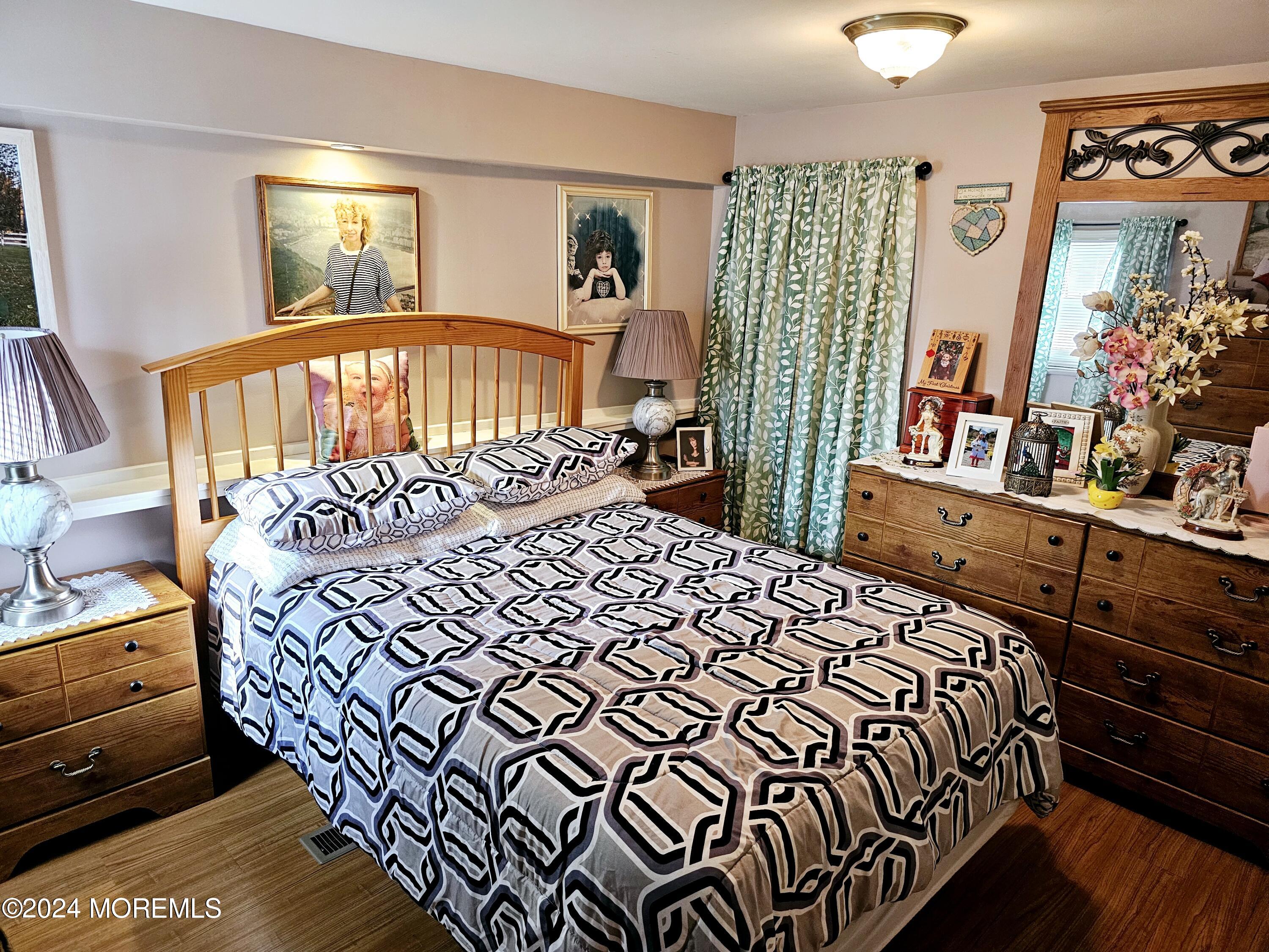 5 Kane Lane Middletown, NJ 07748 - Photo 13 of 23 a bedroom with a bed and a large mirror on the dresser