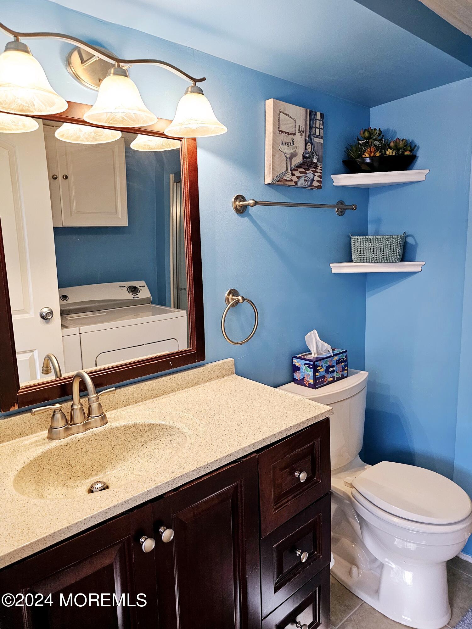 5 Kane Lane Middletown, NJ 07748 - Photo 16 of 23 a bathroom with a sink a toilet and a mirror