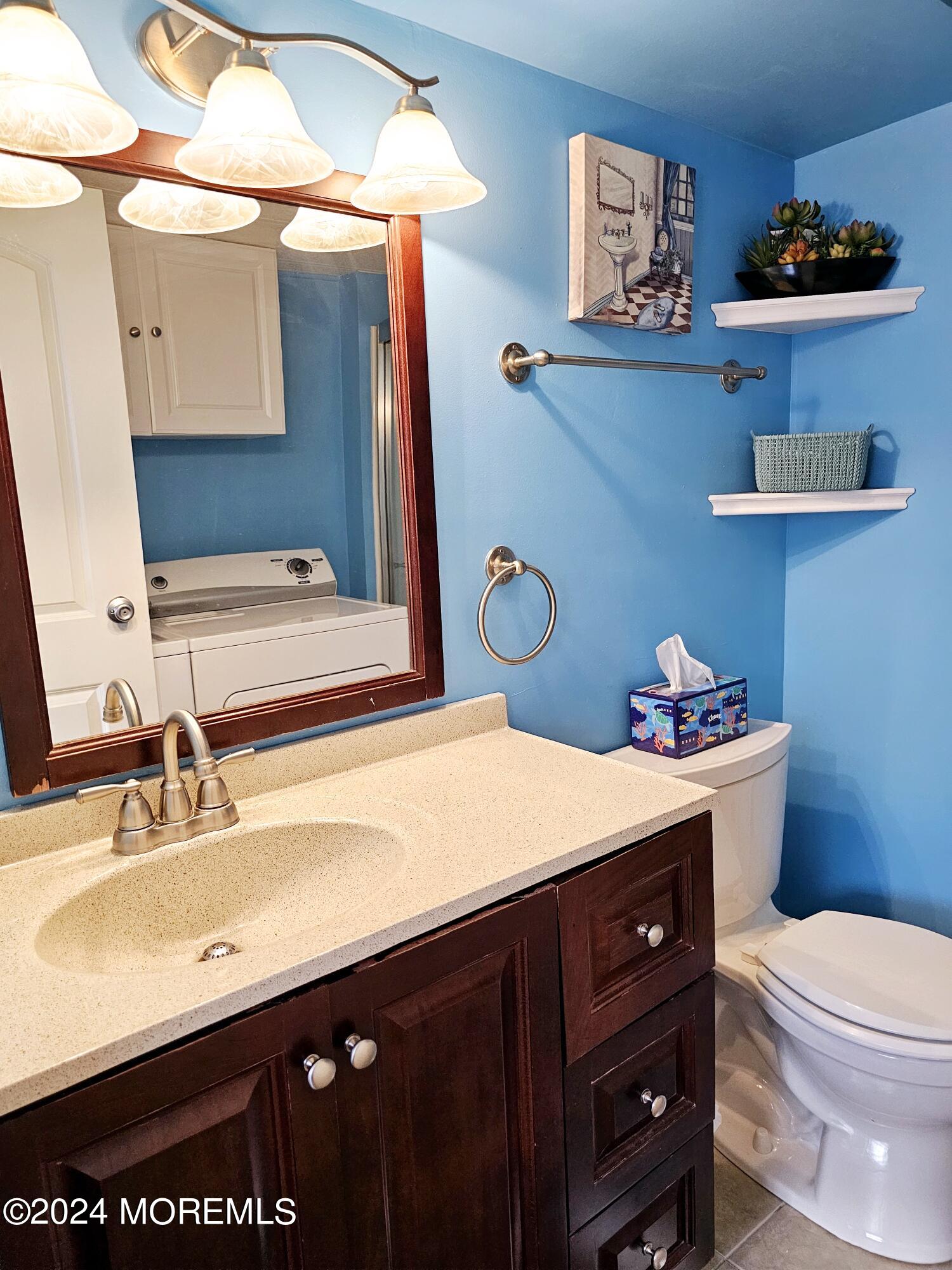 5 Kane Lane Middletown, NJ 07748 - Photo 17 of 23 a bathroom with a sink a toilet and a mirror
