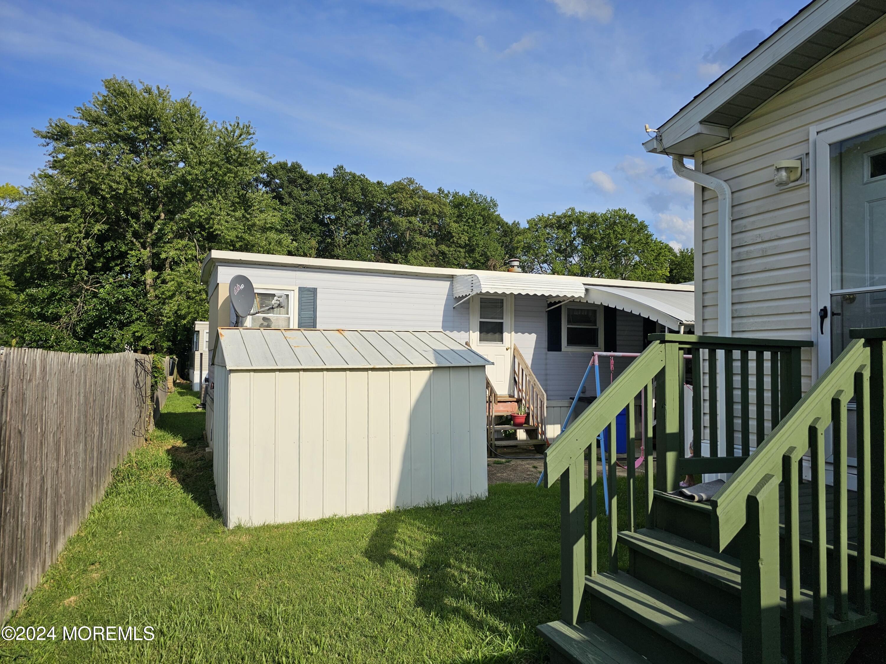 5 Kane Lane Middletown, NJ 07748 - Photo 22 of 23 a view of a house with backyard and a hammock