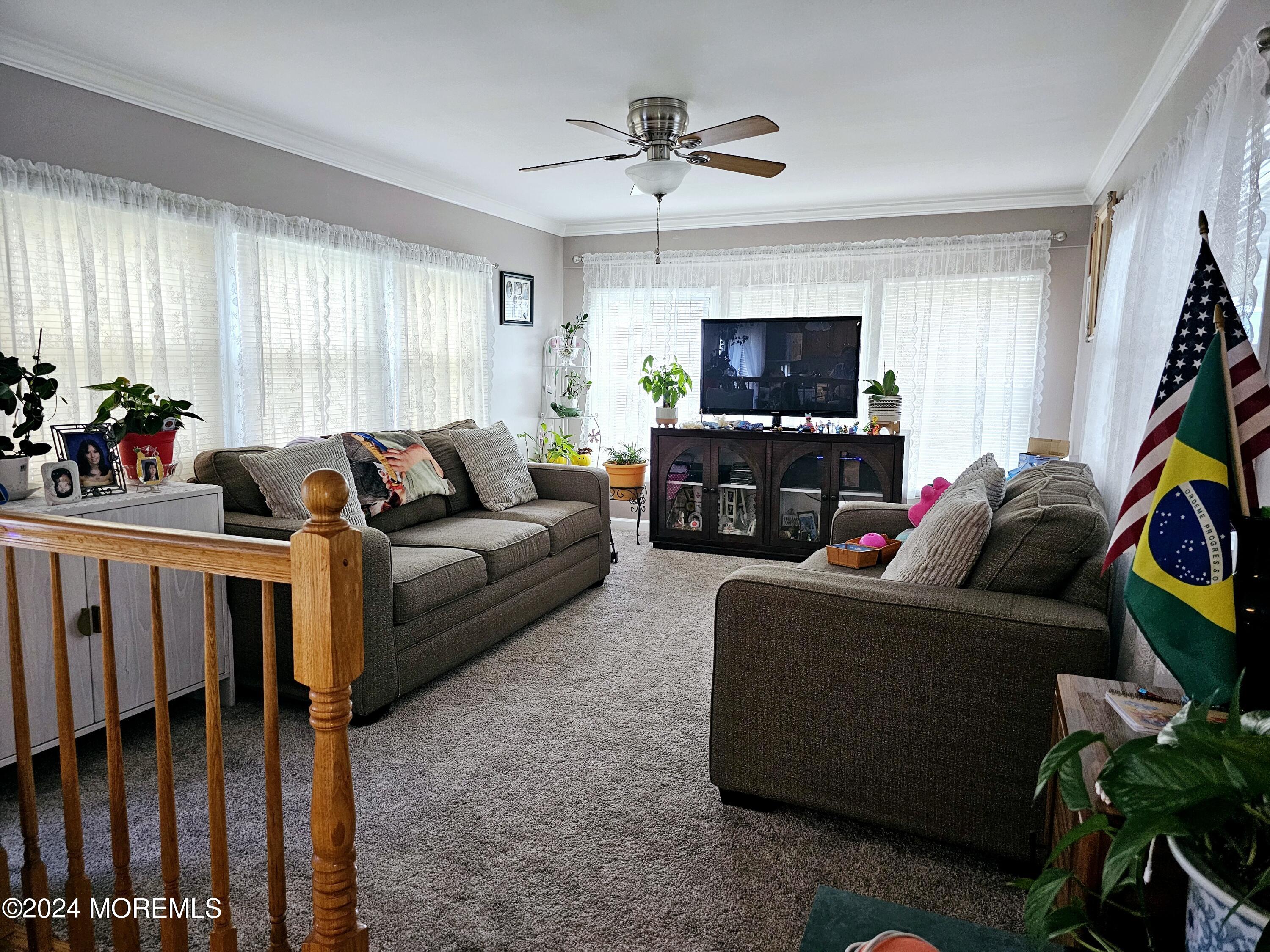 5 Kane Lane Middletown, NJ 07748 - Photo 6 of 23 a living room with furniture a flat screen tv and a window