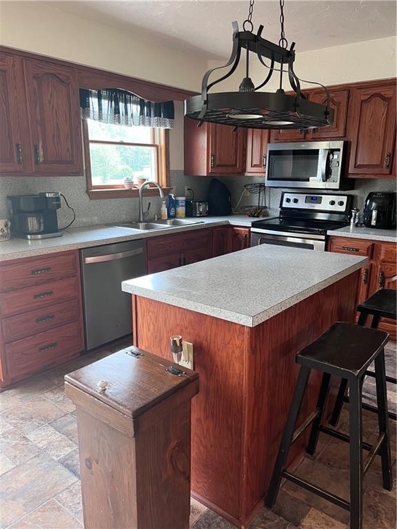 226 Hogback Road Kersey, PA 15846 - Photo 23 of 45 a kitchen with stainless steel appliances a sink a stove a microwave cabinets and a window