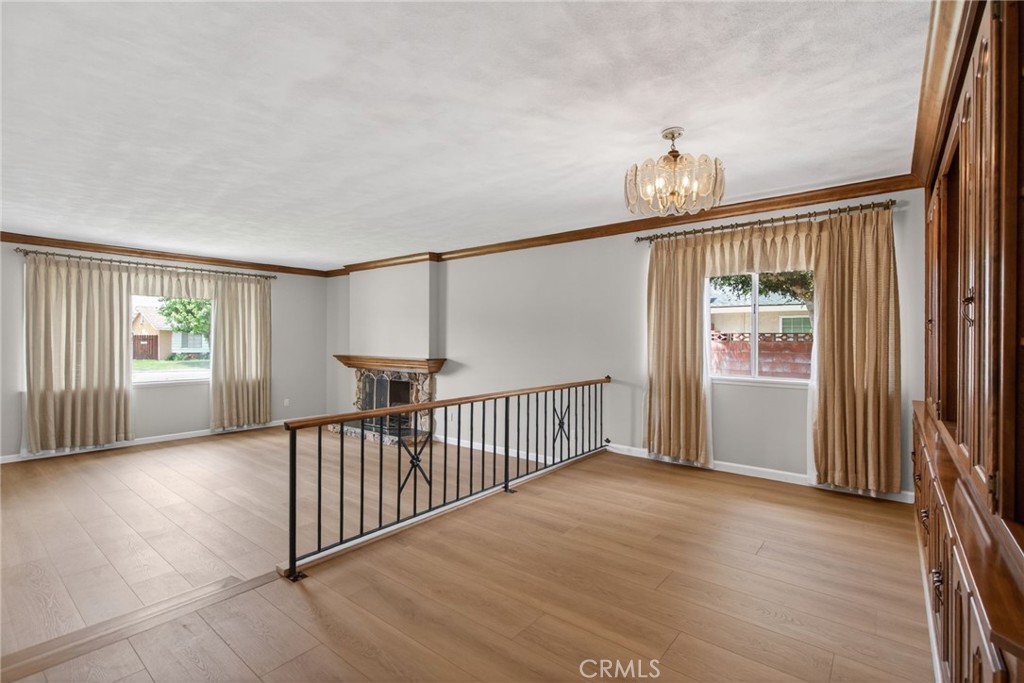 4963 Carlingford Avenue Riverside, CA 92504 - Photo 7 of 33 a view of a hallway with wooden floor and stairs