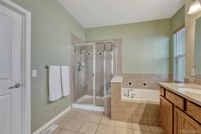 a bathroom with a tub shower and sink