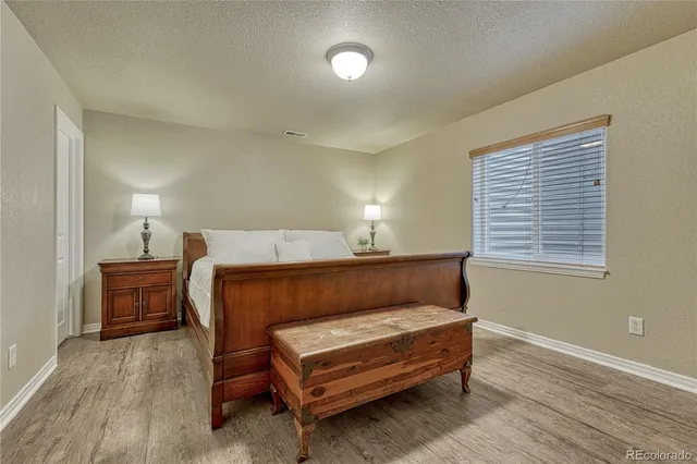 a bedroom with a flat screen tv and a bed