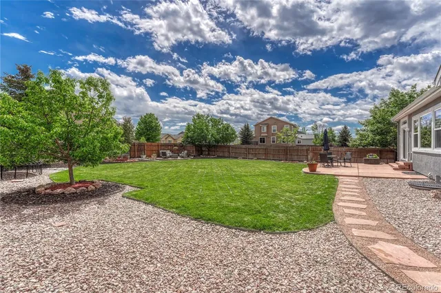 a view of a backyard with sitting area