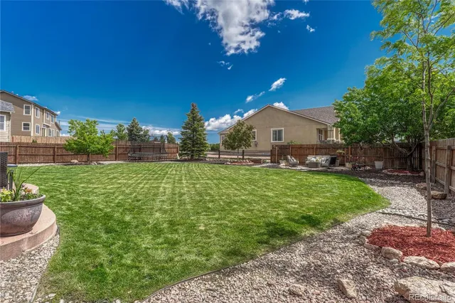 a front view of a house with a garden and plants