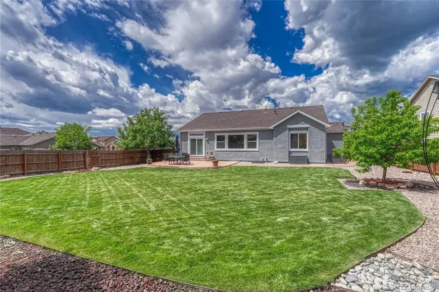 a view of a patio with chairs and a fire pit