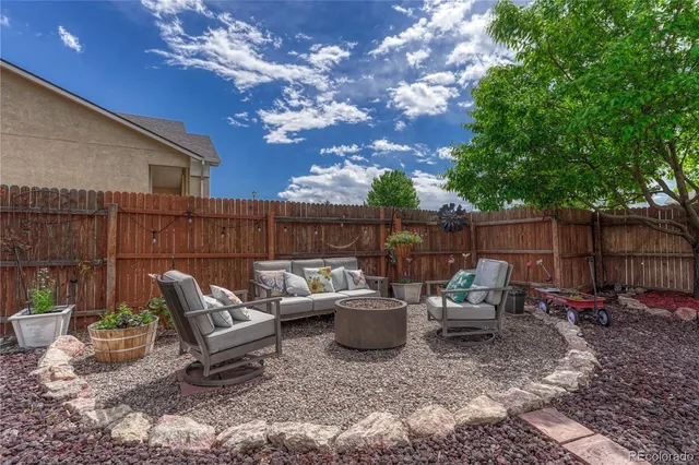 a view of a chair and table in backyard