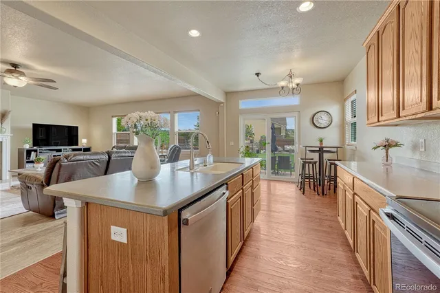 a kitchen with sink stove and refrigerator
