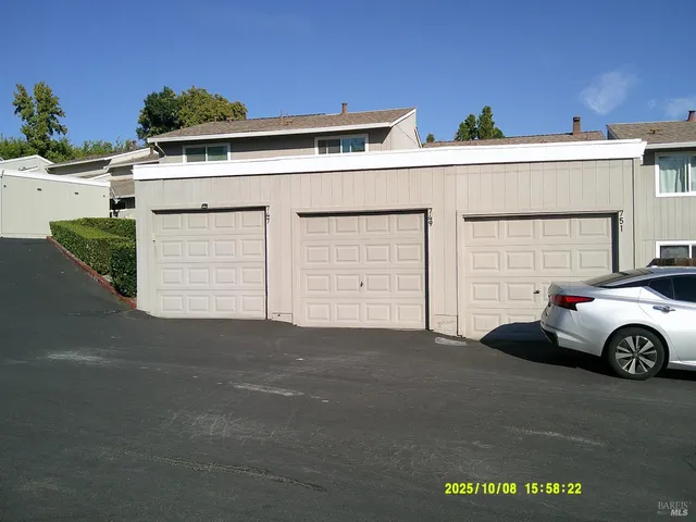 a car parked in front of white house