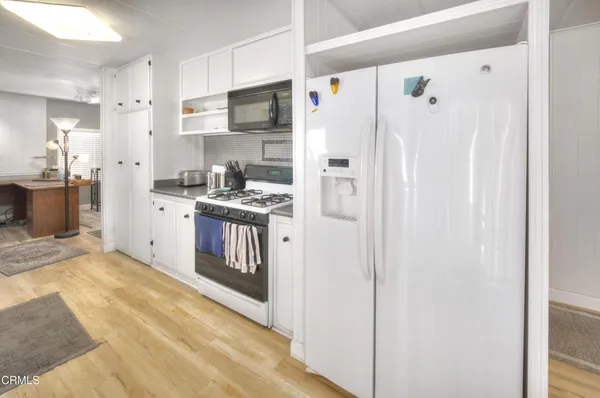 a kitchen with stainless steel appliances a refrigerator stove and sink
