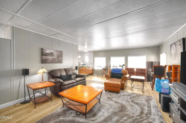 a living room with furniture a rug and a lamp