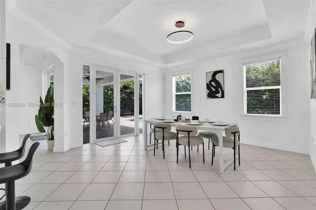 a view of a dining room with furniture and chandelier