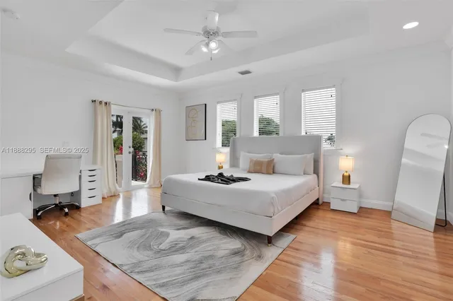 a bedroom with a large bed and wooden floor