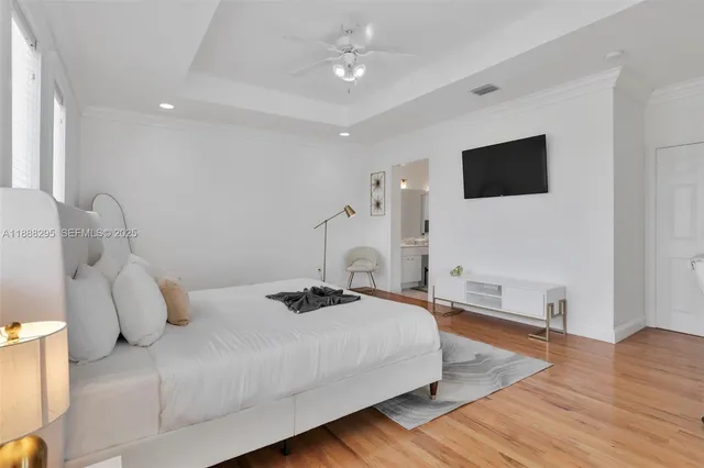a bedroom with a bed and a flat screen tv