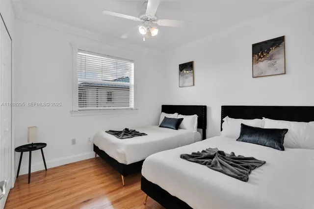 a bedroom with two beds and a chair