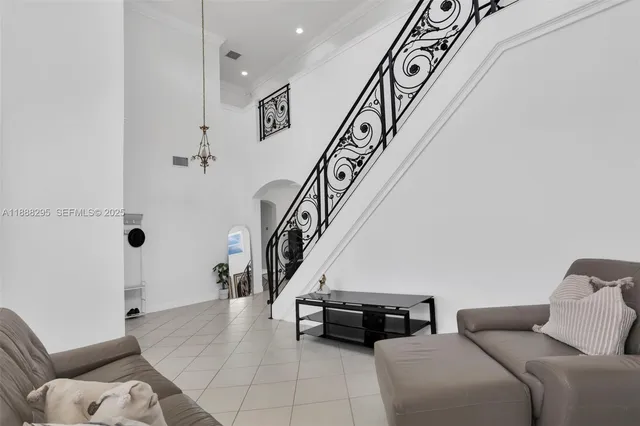 a living room with furniture and stairs