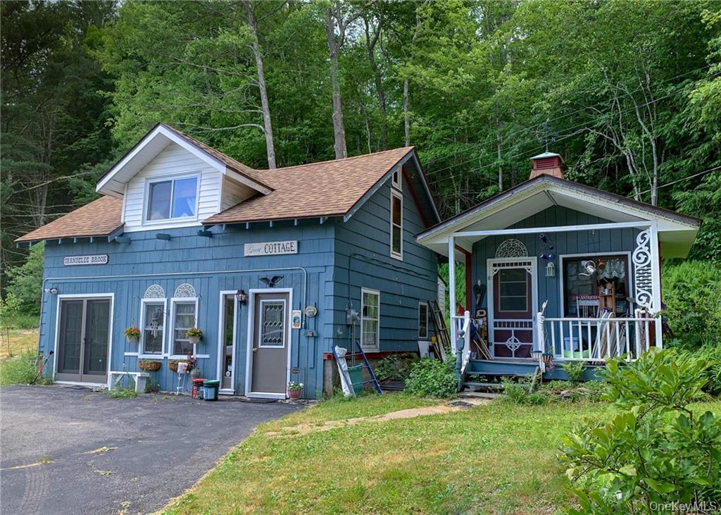 446 Shandelee Road Livingston Manor, NY 12758 - Photo 11 of 33 View of front facade featuring a shingled roof, a porch, and a front lawn