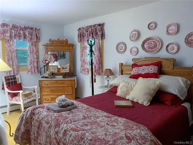 a bedroom with bed and window