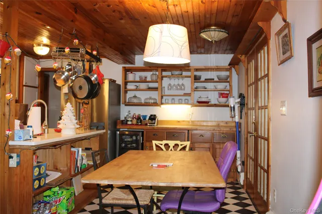 a hallway with a table and a chairs