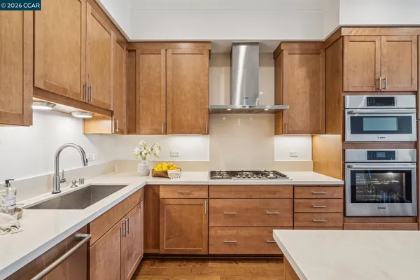 a kitchen with stainless steel appliances granite countertop a sink stove and cabinets