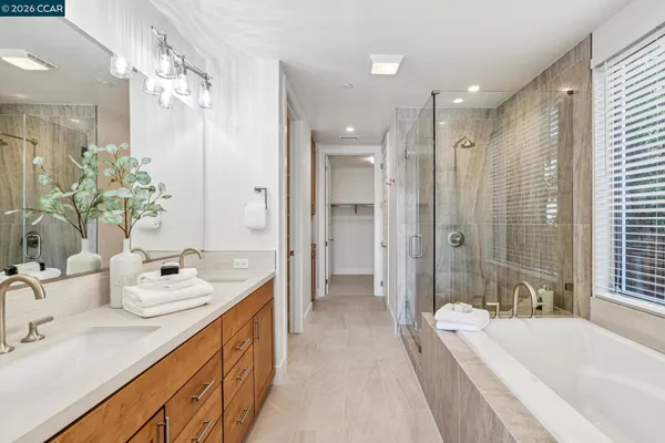 a spacious bathroom with a double vanity sink mirror double and bathtub