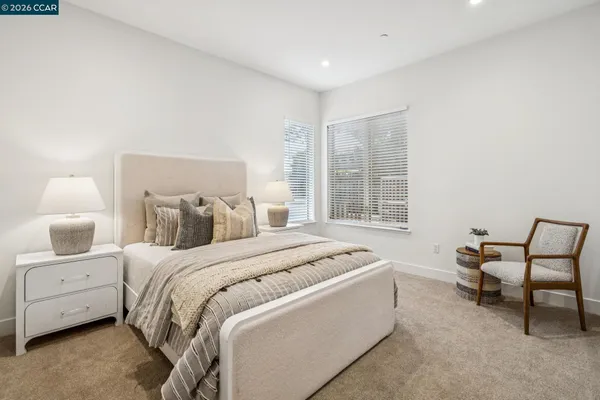 a bedroom with a bed and painting on the wall