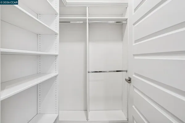 a bathroom with a double vanity sink a large mirror and shower