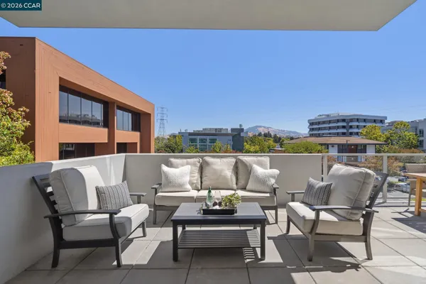 a view of a balcony with two chairs and a table