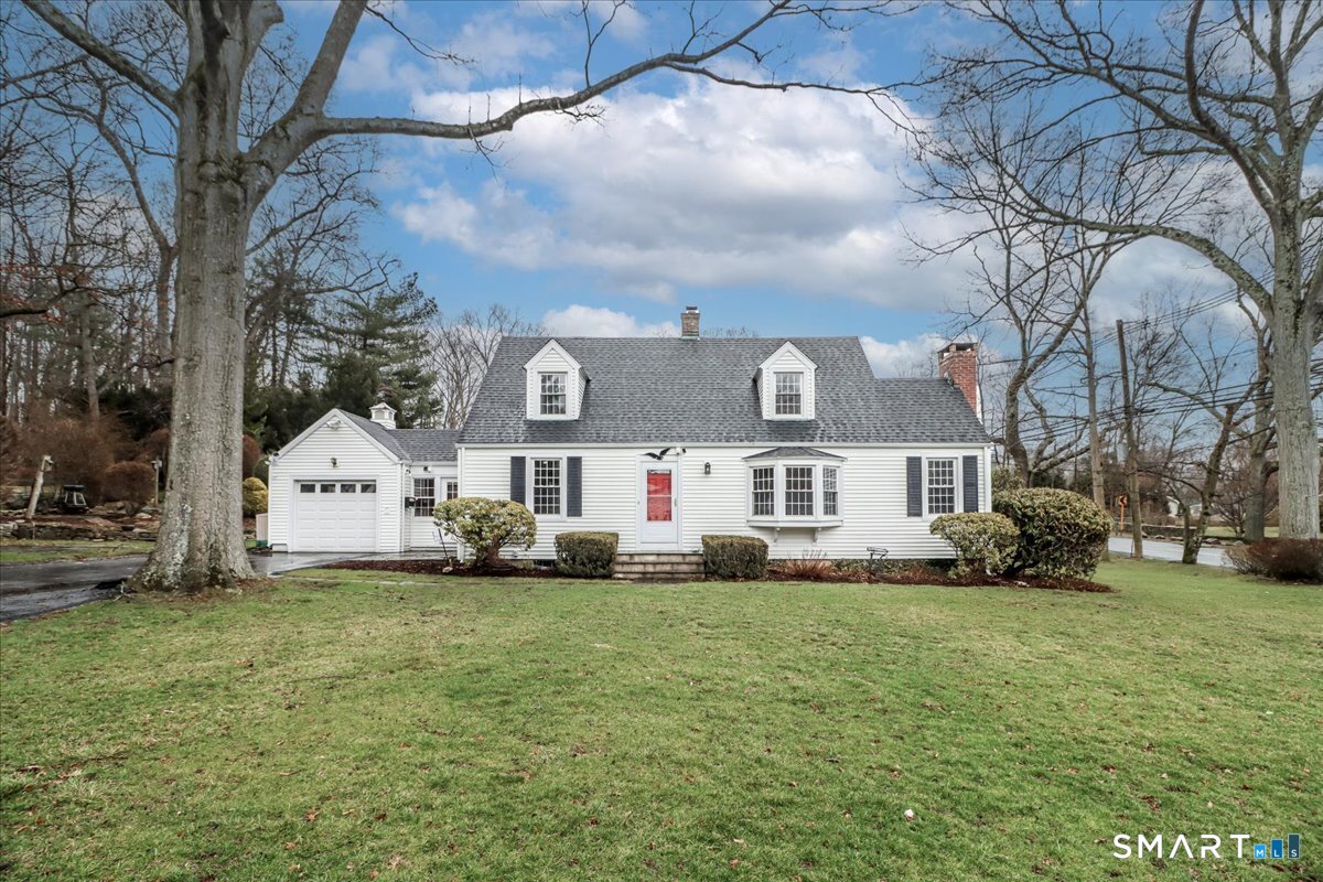 28 Overbrook Road Norwalk, CT 06851 - Photo 1 of 1 a white house that has a tree in front of it