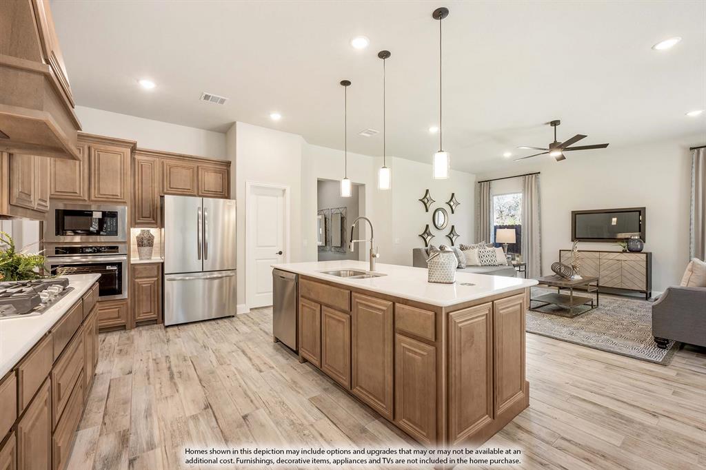 1148 Hitching Post Way Oak Point, TX 75068 - Photo 17 of 31 a kitchen with stainless steel appliances kitchen island granite countertop a sink stove and refrigerator