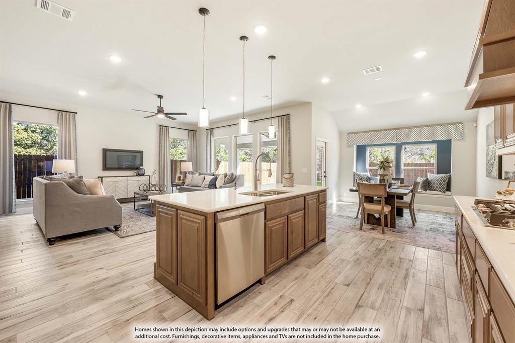 1148 Hitching Post Way Oak Point, TX 75068 - Photo 19 of 31 a large kitchen with stainless steel appliances kitchen island granite countertop a large center island attached withe living room