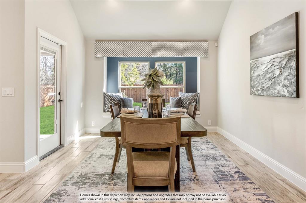 1148 Hitching Post Way Oak Point, TX 75068 - Photo 20 of 31 a view of a dining room with furniture wooden floor and a rug