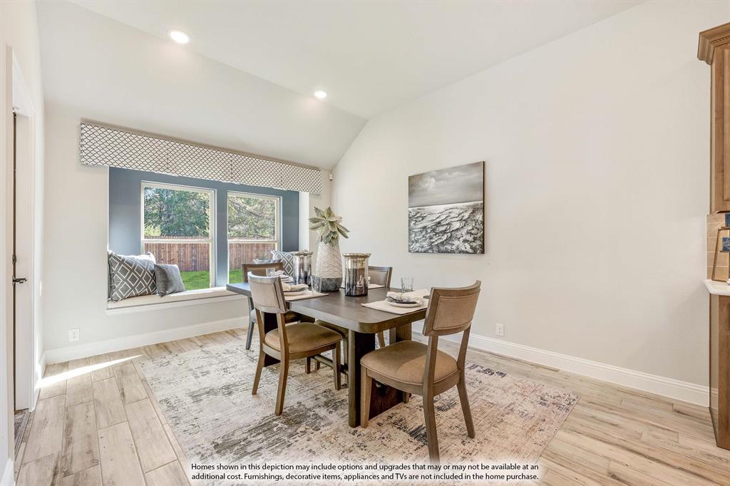 1148 Hitching Post Way Oak Point, TX 75068 - Photo 21 of 31 a view of a dining room with furniture and wooden floor