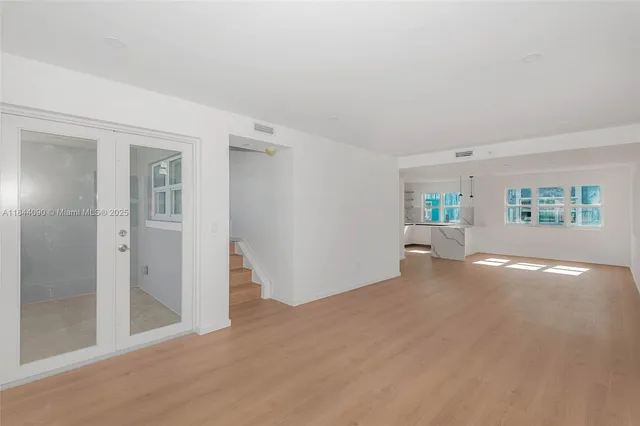 an empty room with windows and closet