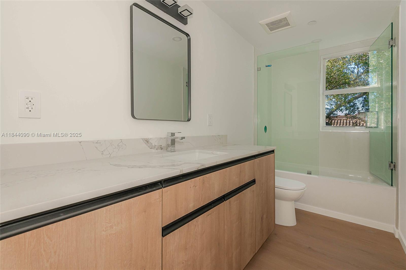 824 Southeast 12th Court, Unit 1 Fort Lauderdale, FL 33316 - Photo 15 of 21 a bathroom with a granite countertop sink a toilet and a bathtub