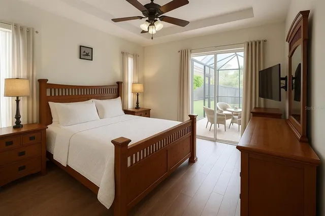 a bedroom with a bed and a flat tv screen on dresser