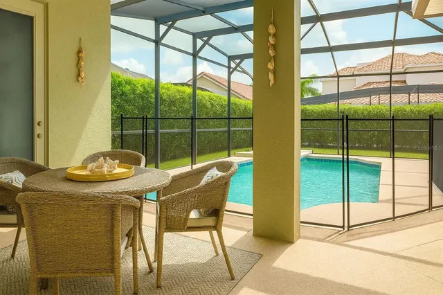 a view of a dining room with furniture and a window