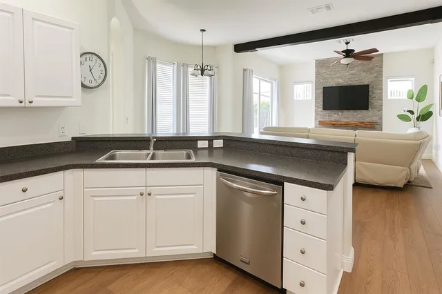a kitchen with white cabinets and a sink