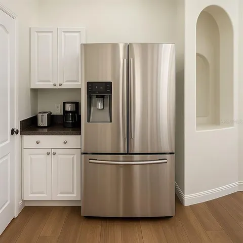 a kitchen with appliances a refrigerator and cabinets