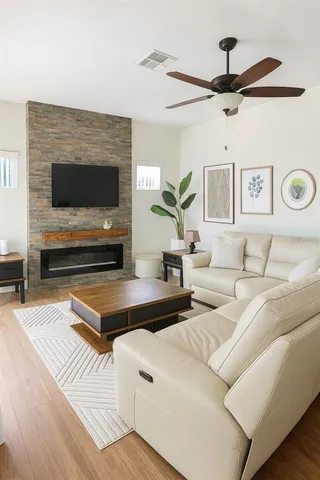 a living room with furniture and a flat screen tv