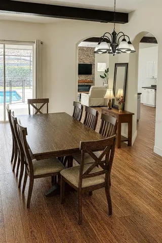 a view of a dining room with furniture and wooden floor