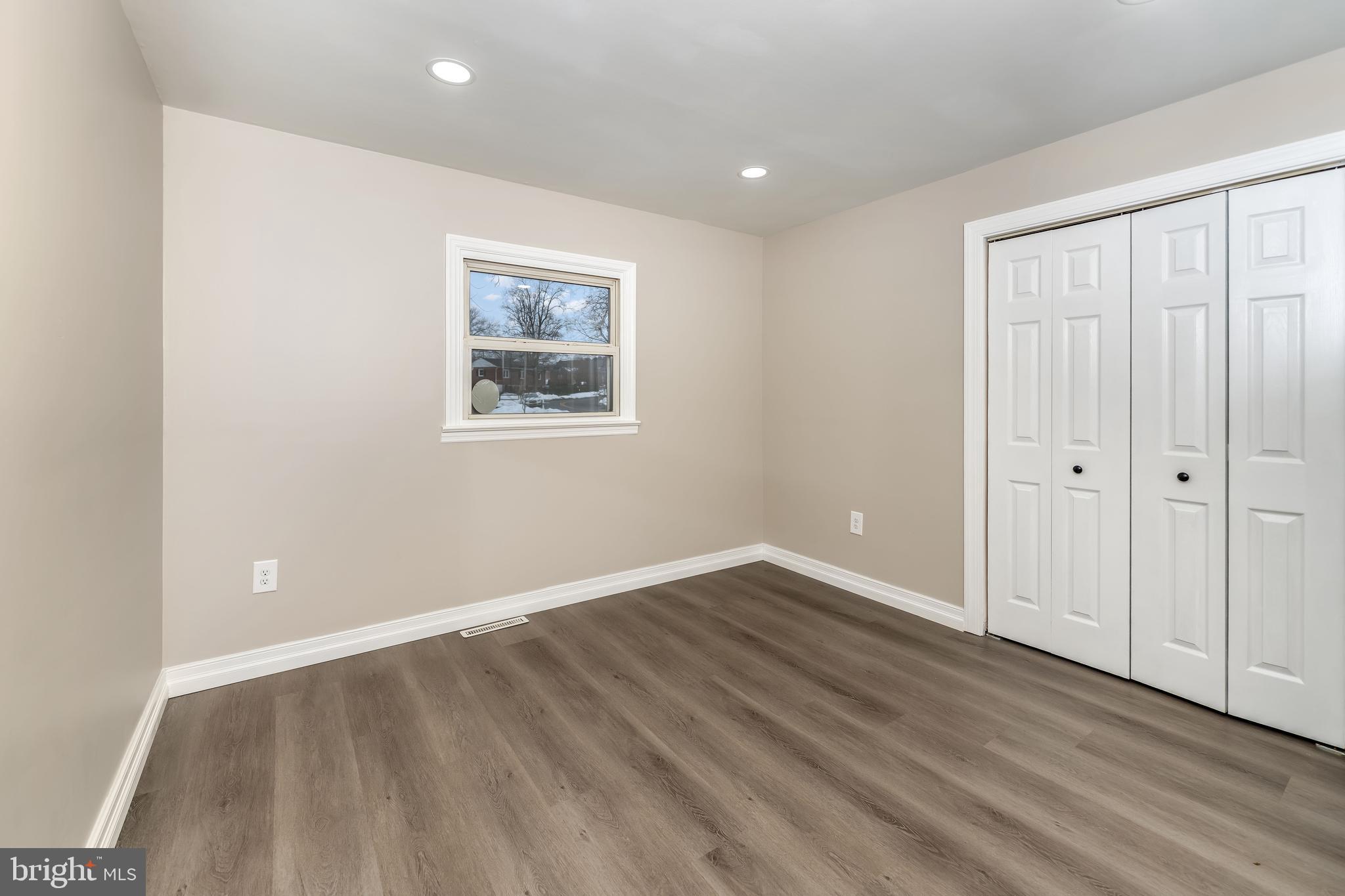 106 Rutherford Road Harrisburg, PA 17109 - Photo 12 of 27 an empty room with wooden floor and windows